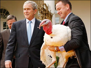 George W. Bush with a turkey about to be "pardoned."